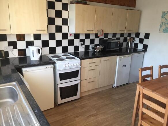 Bright, practical kitchen with checkerboard til...