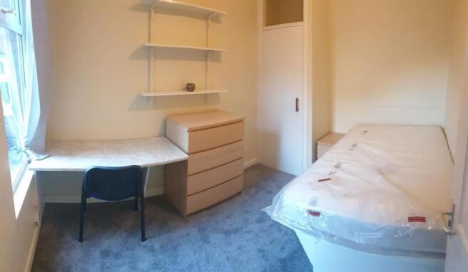 Bright single bedroom with a window-side desk, ...