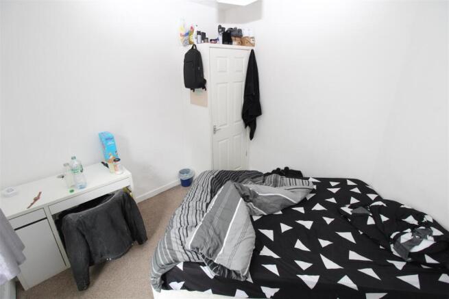 Bright bedroom with desk and built-in storage...
