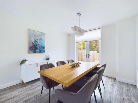 Bright, modern dining area with a large wooden ...