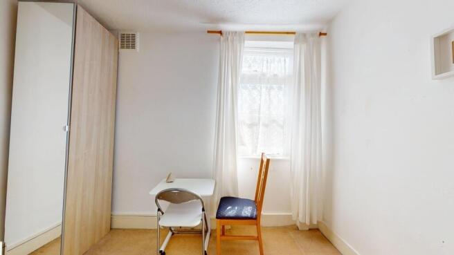 Bright study area with desk and ample storage...