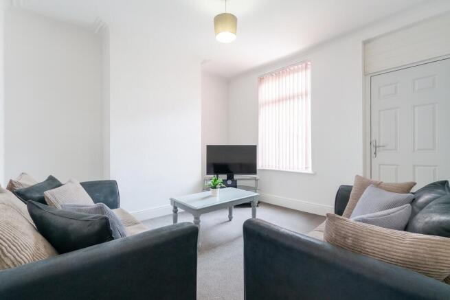 A bright, well-maintained living room featuring...