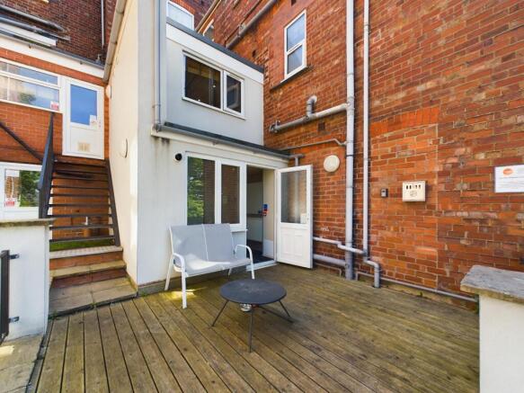 Private paved courtyard with seating area and d...