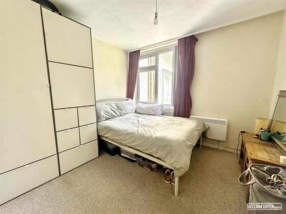 Bright bedroom with wardrobe and window...