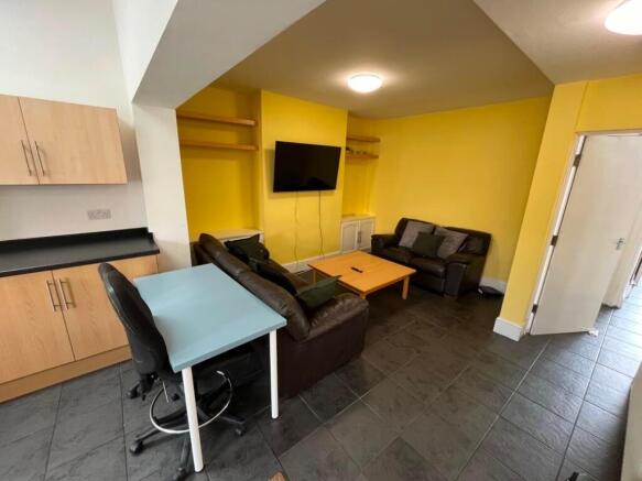 Bright, modern living area with bold yellow fea...