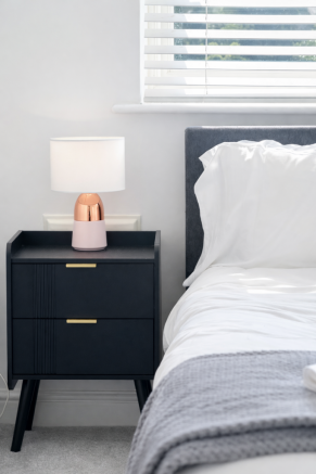 Modern bedside haven with copper accents