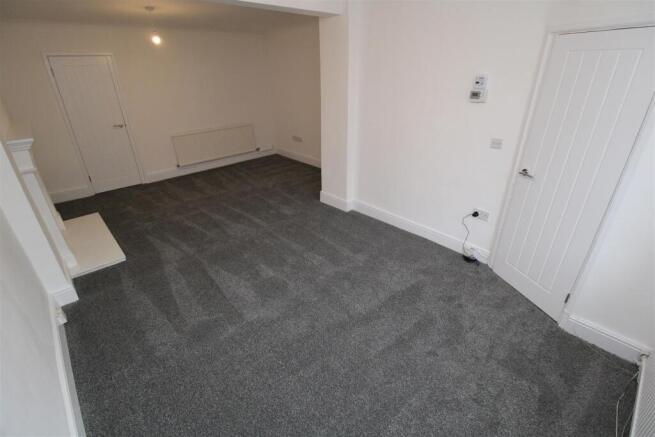 Bright and spacious room with fresh gray carpet...