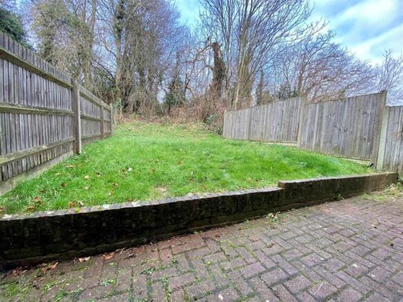 Private fenced garden with paved patio and lawn...