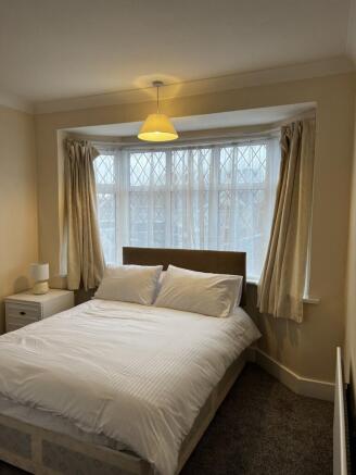 Bright, neatly presented bedroom with a comfort...