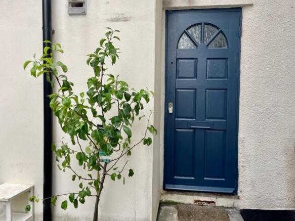 Charming entrance with a freshly painted deep-b...