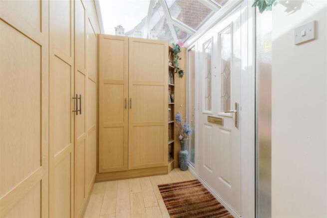 ENTRANCE PORCH WITH EXPANSIVE STORAGE
