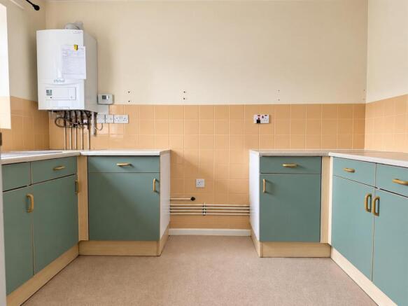compact_sage_green_utility_kitchen_with_boiler.jpg