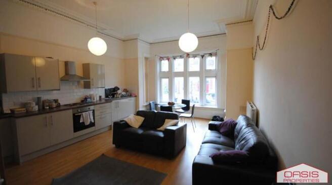 Bright open-plan living area with a fitted kitc...