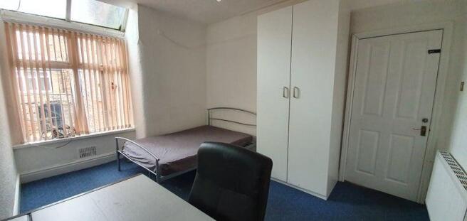 Bright bedroom with large window and storage...