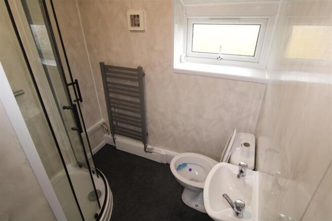 Modern bathroom with sleek shower and towel rai...