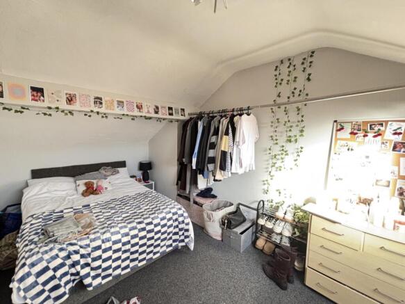 Cozy bedroom featuring a double bed and ample n...