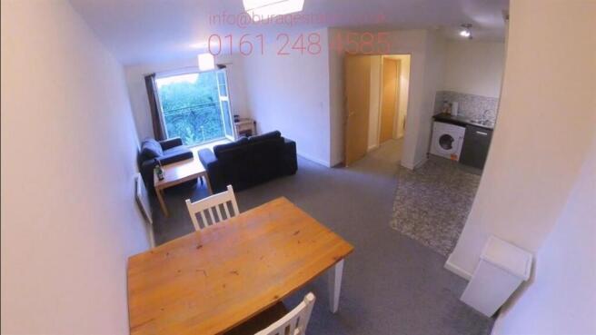 Bright open-plan living area with a dining tabl...