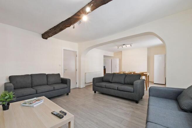 Bright, open-plan living area with modern grey ...