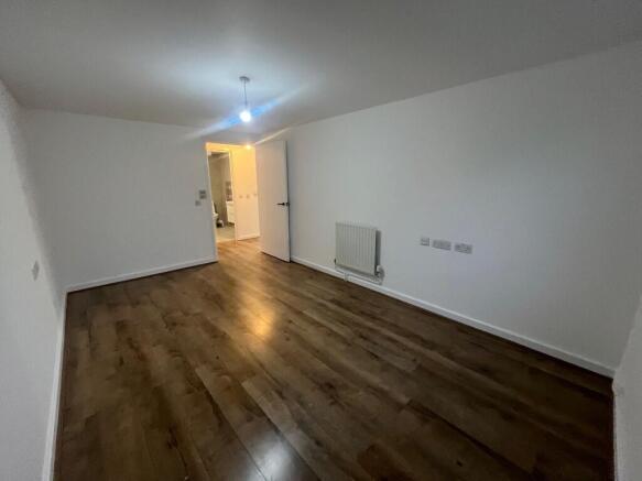 Bright living room with wood flooring and neutr...