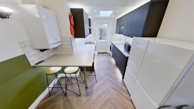 Modern kitchen with breakfast bar and skylight...