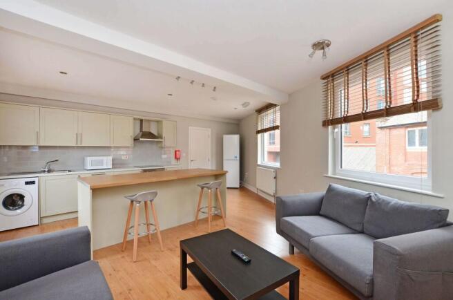Bright and spacious living room featuring large...