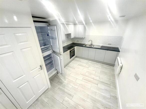 Modern kitchen with sleek white cabinets....