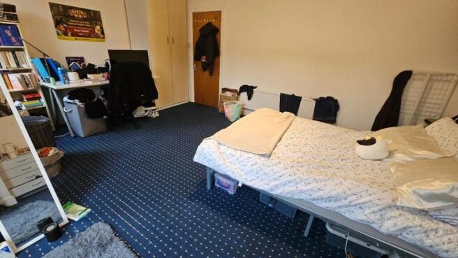 Spacious bedroom with a dedicated study area...