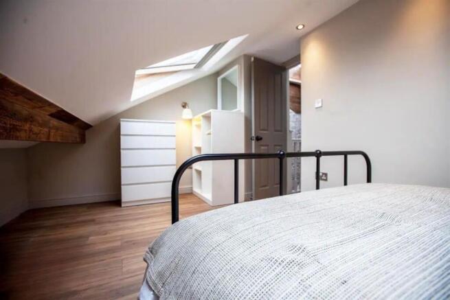 Bright attic double bedroom with skylight...