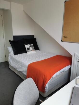 Bright, neatly presented bedroom with a made do...