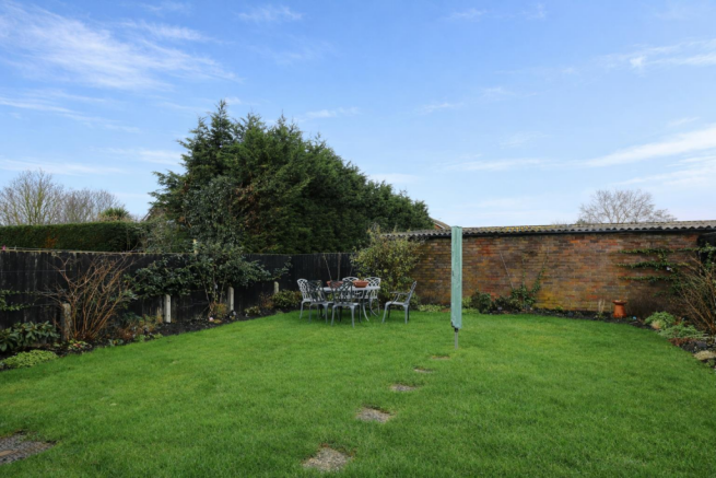 Sunny garden with patio furniture.png