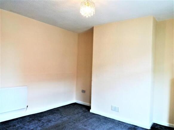 Bright, neutrally painted bedroom with fresh cr...