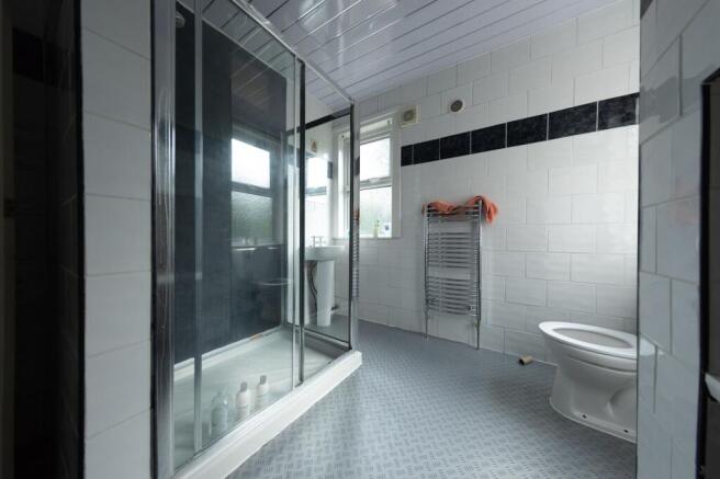 A tidy bathroom featuring a large shower cubicl...