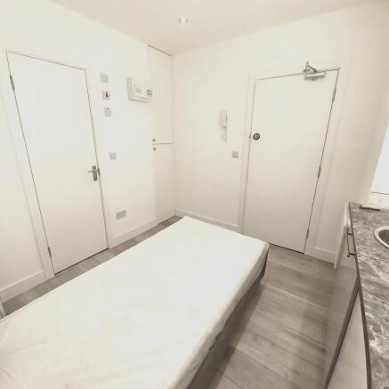 Bright, simply furnished single bedroom with a ...