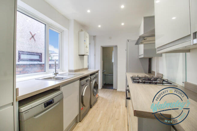 Refitted kitchen towards bathroom
