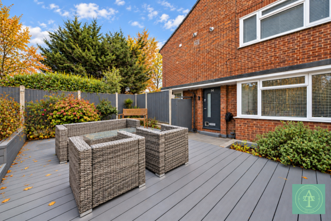 Modern Brick House Patio with Autumn Planting