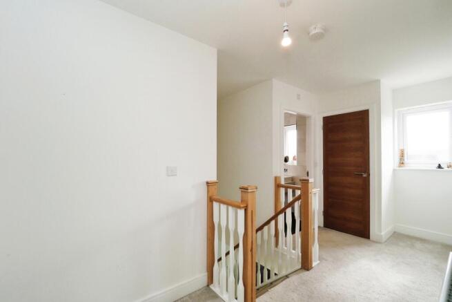 Generous landing with storage cupboard