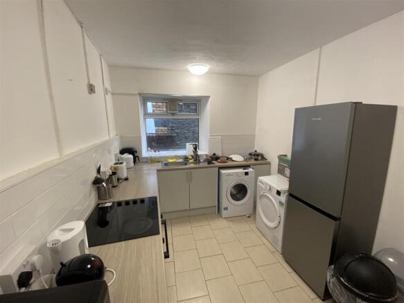 Bright kitchen with modern appliances and stora...