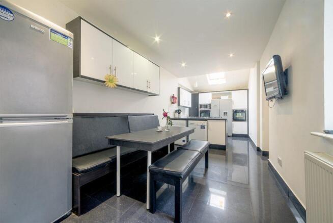 Bright modern kitchen with integrated dining be...