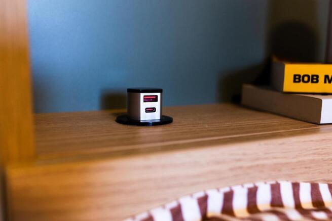 Cozy bedside shelf with built-in power outlet a...