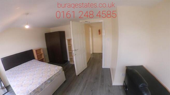 Bright, simply furnished bedroom with ample flo...