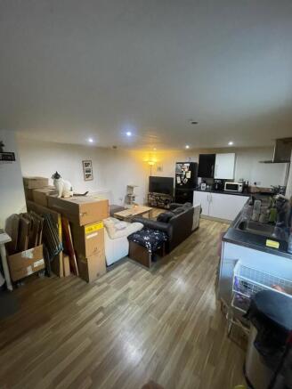 Open-plan living area with laminate floors, com...