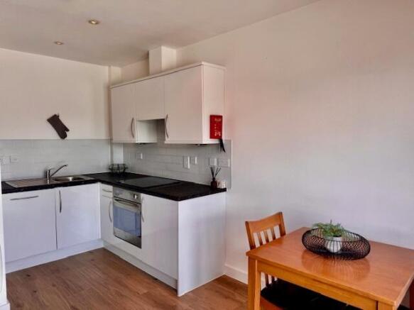 Modern kitchen with bright white cabinetry...