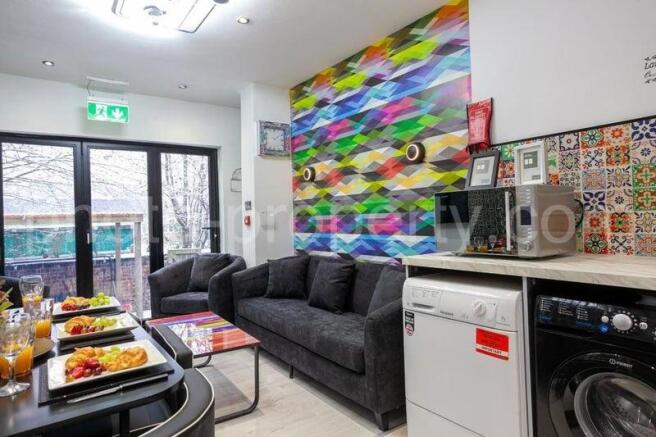 Bright, modern communal lounge with comfortable...