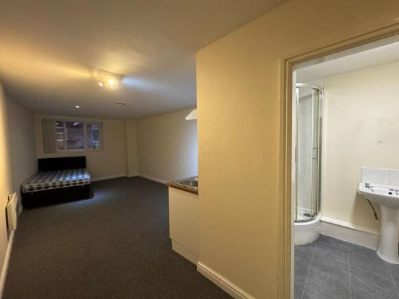 A functional bathroom with a shower cubicle, si...