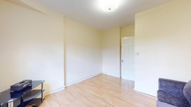 Bright and airy lounge with sleek wooden floori...