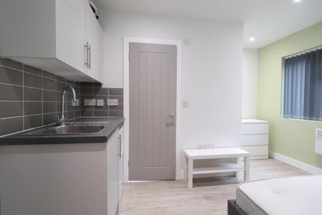 Bright, modern bedroom with a fitted kitchenett...