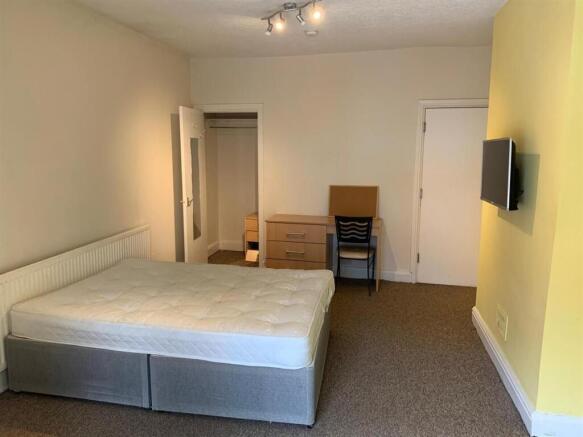 Bright, neutrally decorated double bedroom with...