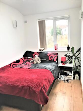 A cozy double bedroom featuring a comfortable b...