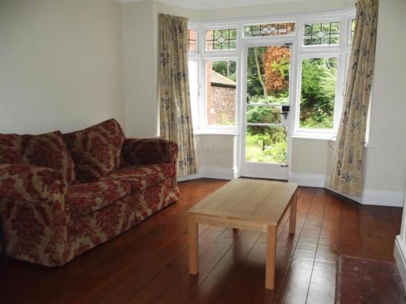 Bright living room with large windows and sofa...