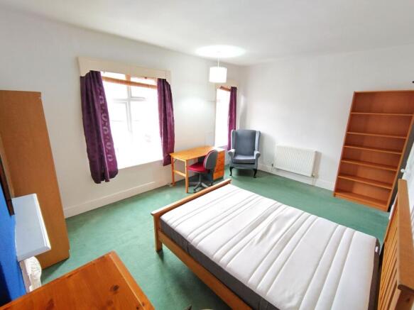 Spacious bedroom with ample storage and desk...